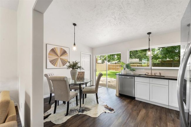 Open-concept layout with seamless flow to dining area. | Image 9
