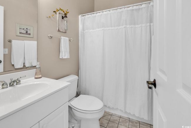 Full Guest Bathroom with toilet, vanity, tile patterned floors, and a shower with curtain | Image 8