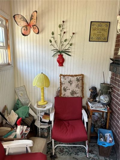 A cozy sunporch greets you as you enter the home. | Image 2