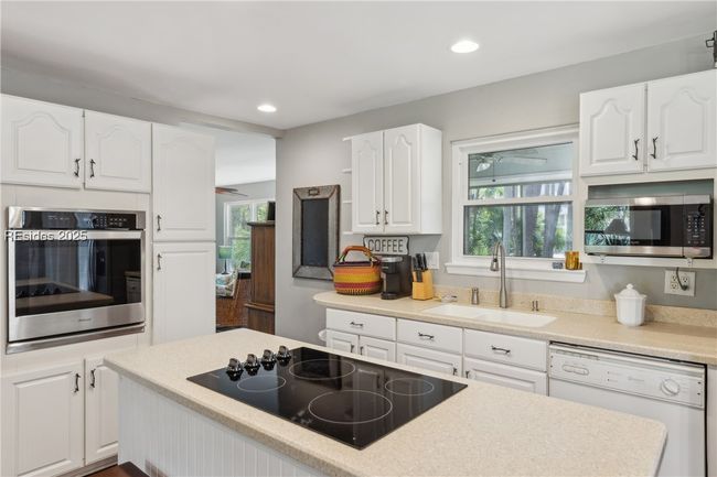 Updated chef's kitchen with stainless steel appliances & ample storage, efficient flow and a window over the sink for a view while prepping and cooking. | Image 18