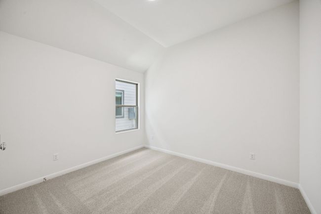 Empty room with light carpet and vaulted ceiling | Image 28