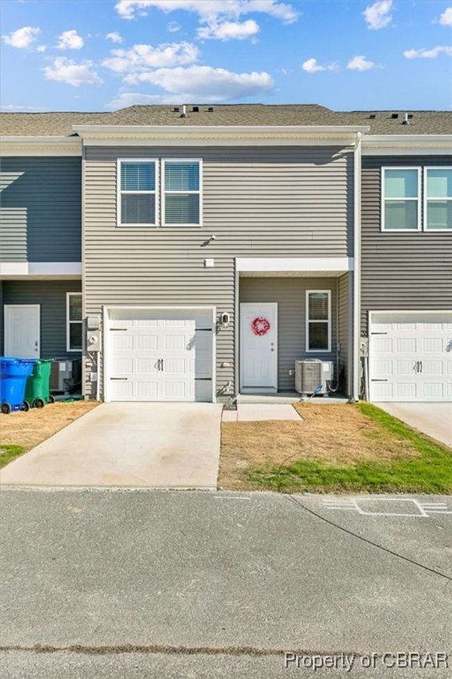 View of property with driveway, cooling unit, and a garage | Image 31
