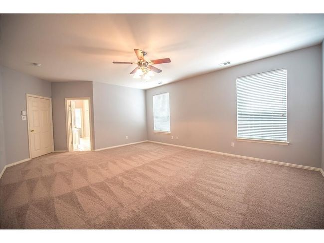 Spare room with carpet floors, a ceiling fan, and baseboards | Image 13