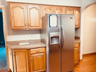 Kitchen with stainless steel fridge and light hardwood / wood-style flooring | Image 2