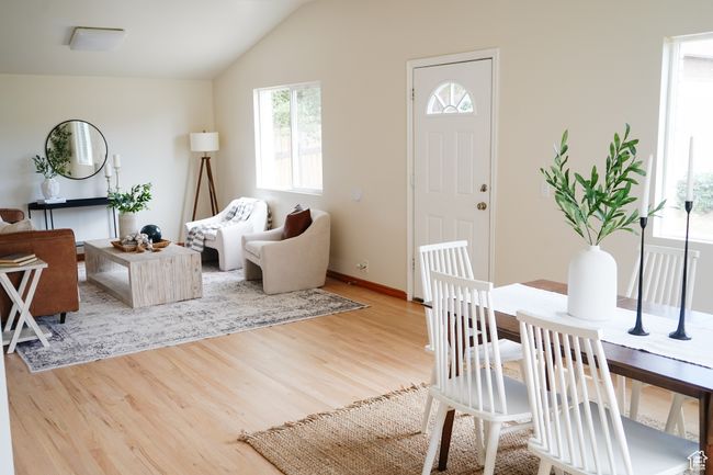 Living area featuring vaulted ceiling and light wood-style floors | Image 12