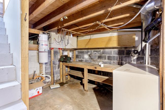 Unfinished below grade area with a workshop area | Image 32