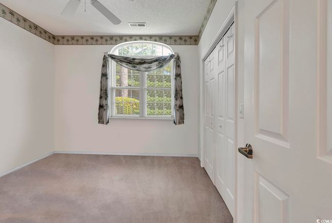 Bedroom #3 featuring carpet flooring, a closet, a ceiling fan, baseboards, and a textured ceiling | Image 9