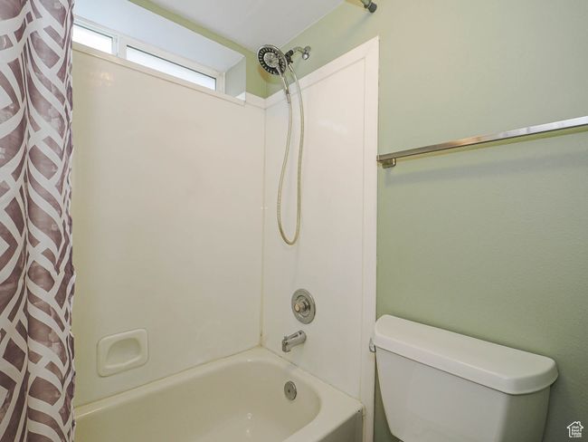 Full bathroom with toilet and shower / bath combination with curtain | Image 18