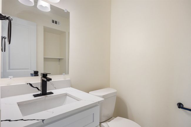 Half bathroom featuring vanity and toilet | Image 16