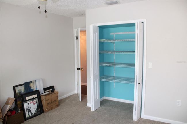 Guest bedroom closet with shelves | Image 23