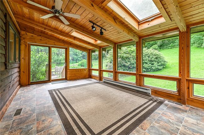 10x19 sunroom with 2 sliding doors accessing the private, fenced in back yard. | Image 14