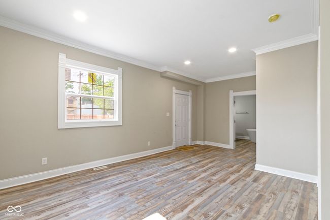 empty room with ornamental molding, light wood-type flooring, baseboards, recessed lighting, and a smoke detector | Image 20