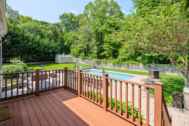 Deck featuring a storage shed, a fenced backyard, and a patio | Image 36