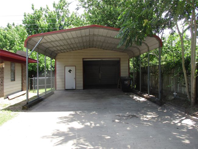 View of vehicle parking featuring a garage | Image 9