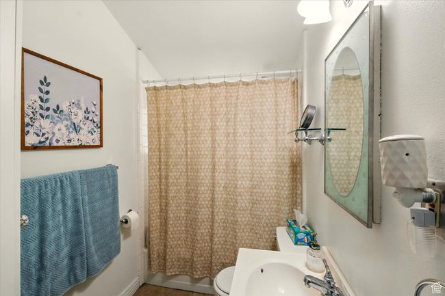 Bathroom featuring toilet and shower / tub combo | Image 14