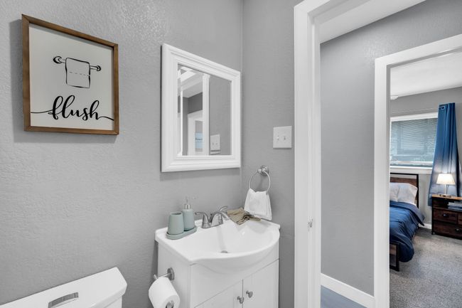 Ensuite bathroom featuring ensuite bathroom, baseboards, toilet, vanity, and a textured wall | Image 23