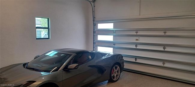 19' x 24' garage dimensions, wind rated door with sidelights and 12'-6" ceiling height. Side bar auto garage door opener is quiet and not over any vehicles. | Image 20