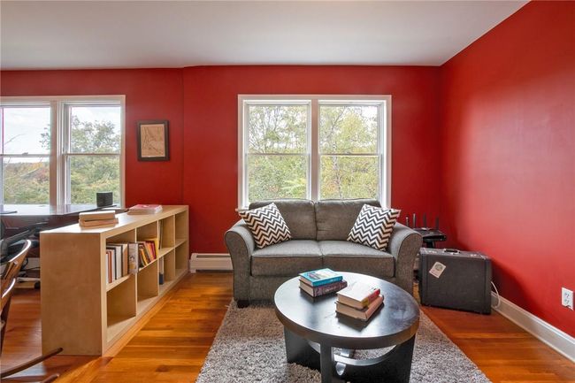Living room featuring wood-type flooring, a wealth of natural light, and a baseboard radiator | Image 12