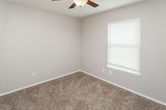 Unfurnished bedroom featuring carpet, a closet, and a ceiling fan | Image 26