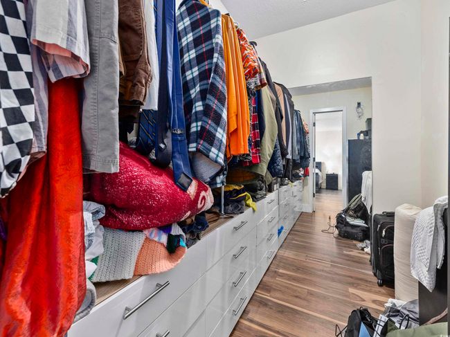Walk in closet featuring wood finished floors | Image 19