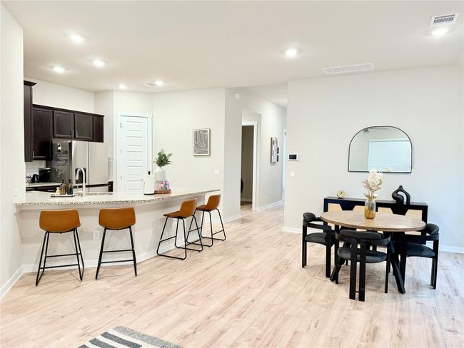 Dining Room, kitchen bar, light wood-style floors, and recessed lighting | Image 10