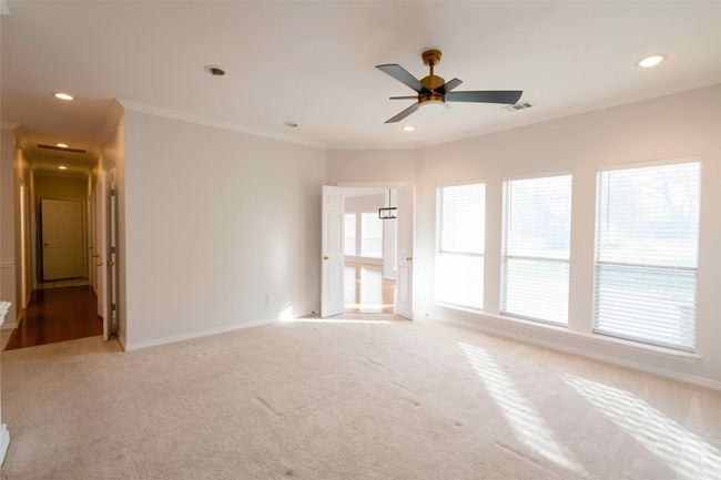 Unfurnished room featuring light colored carpet, crown molding, recessed lighting, and ceiling fan | Image 11