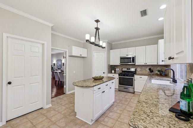 The heart of the home: an open-concept kitchen with ample cabinetry and prep space. | Image 16