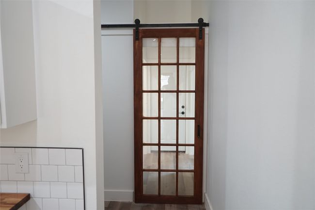 Detailed view of a barn door and wood finished floors | Image 13