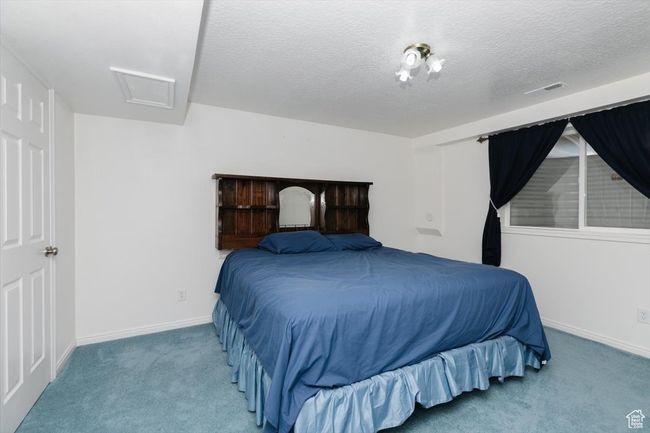 Bedroom with carpet, attic access, and a textured ceiling | Image 57