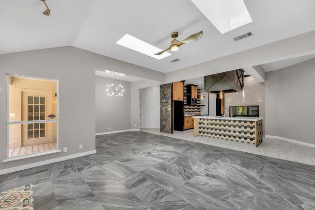 View to the kitchen and breakfast area from the living room. | Image 10