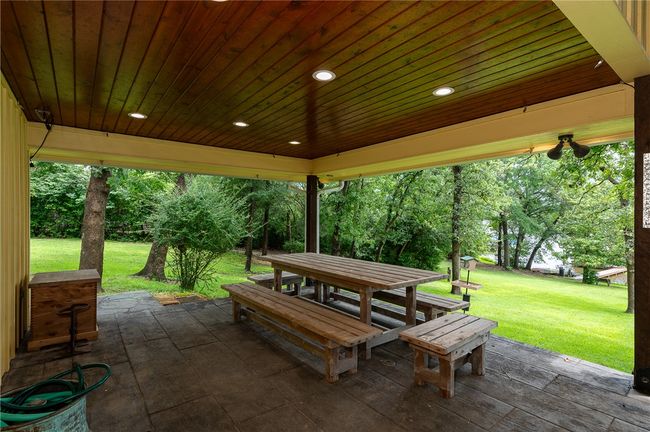 View of patio featuring outdoor dining area and view of scattered trees | Image 19