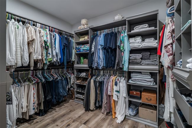 Spacious closet with wood finished floors | Image 23