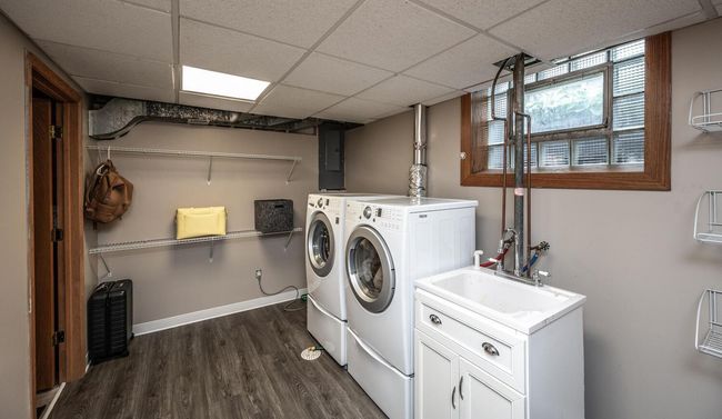 Lower level laundry area with new flooring (2024). Additional storage area through the door on the left. A/C & water heater both new in 2023. | Image 28