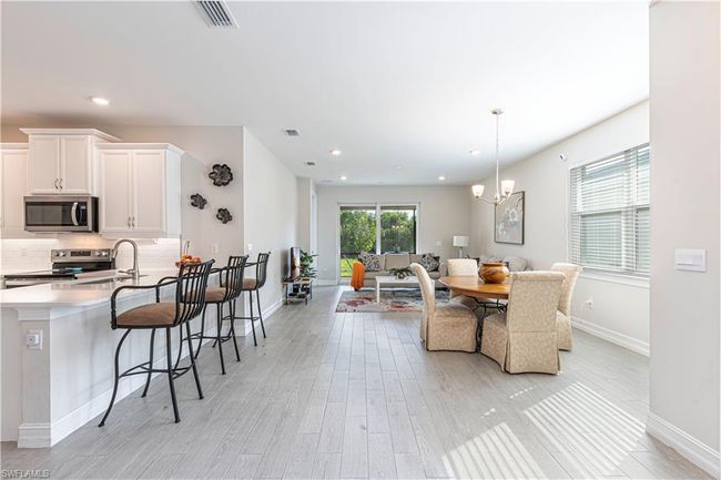 Dining room featuring recessed lighting, visible vents, light wood-style flooring, and an inviting chandelier | Image 6