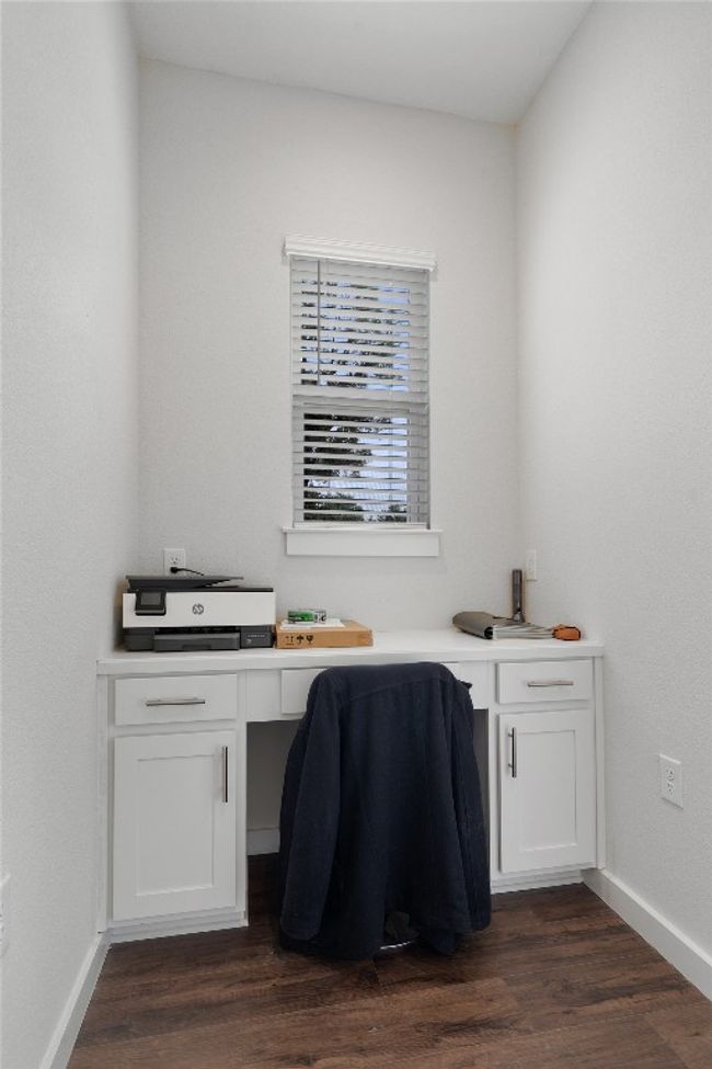 Office with dark wood-style flooring and built in study area | Image 16