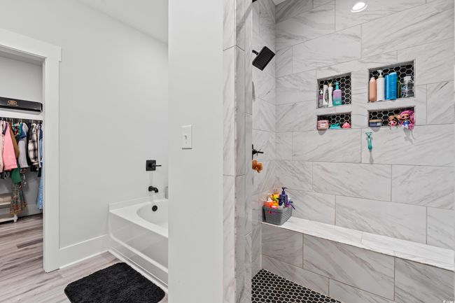 Full bathroom with tiled shower, wood finished floors, and a bathtub | Image 21