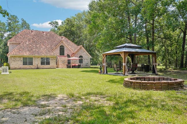 The backyard includes a gazebo and a fire pit. | Image 40