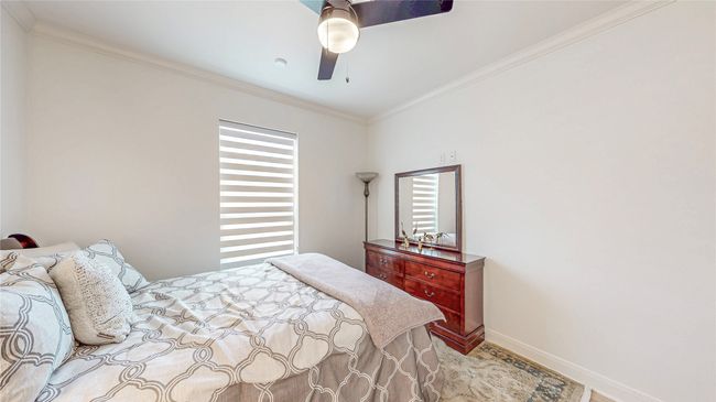 Bedroom featuring ornamental molding, wood finished floors, and ceiling fan | Image 25