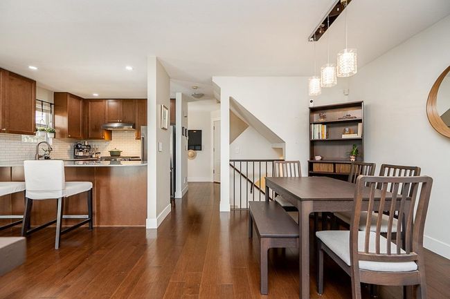 Dining area featuring dark wood-style flooring, baseboards, and recessed lighting | Image 9