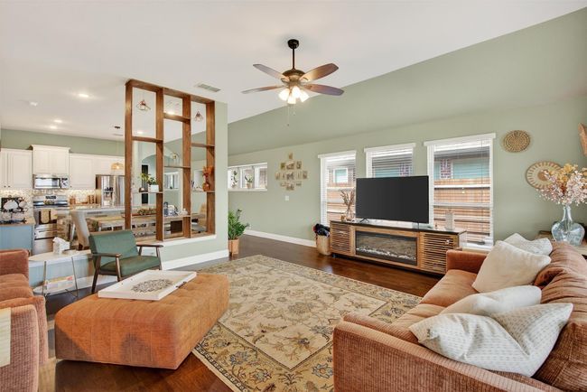 Living room with ceiling fan, wood finished floors, recessed lighting, and vaulted ceiling | Image 19