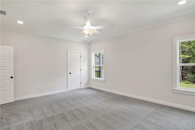 Carpeted empty room featuring recessed lighting, ceiling fan, ornamental molding, and baseboards | Image 26