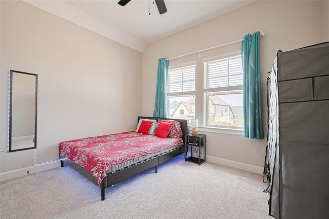 Each secondary bedroom is thoughtfully designed with comfort in mind, offering soft carpeting, ample closet space, and large windows that bring in natural light | Image 25