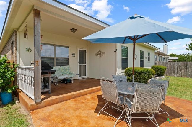 back of house with covered porch and extended stained porch patiio | Image 27