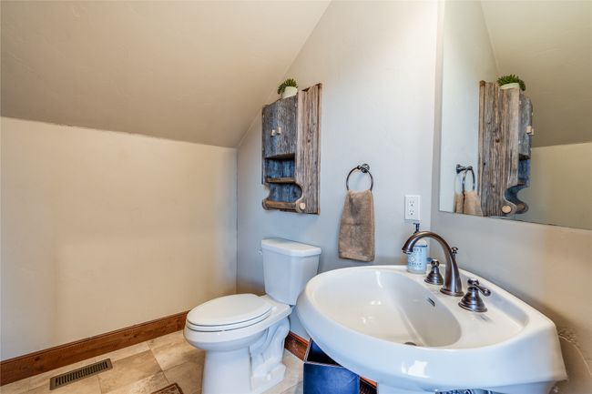 Caretaker Quarters / Guest House. Bathroom featuring visible vents, toilet, a sink, baseboards, and vaulted ceiling | Image 85