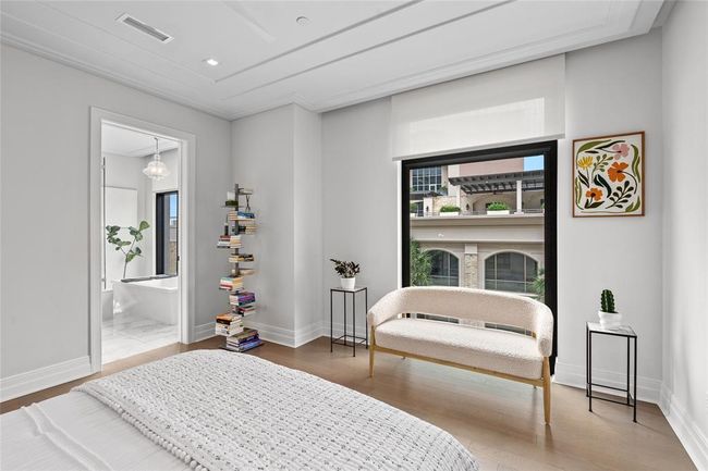 [Primary Bedroom] Alternate view of sitting area, boasting CitiQuiet soundproof window - with motorized shade, adding additional 3/8" laminated glass for an exceptionally quiet night's sleep | Image 21