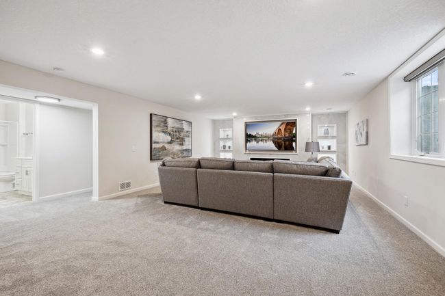 Lower level living room boasting a wonderful accent wall | Image 26
