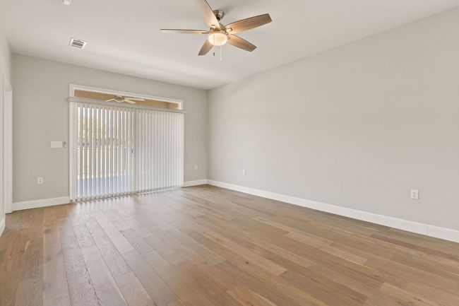 Empty room featuring a ceiling fan, baseboards, light wood-style floors, and visible vents | Image 16