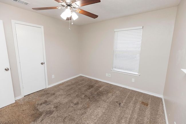 Unfurnished room with carpet flooring, ceiling fan, and baseboards | Image 19