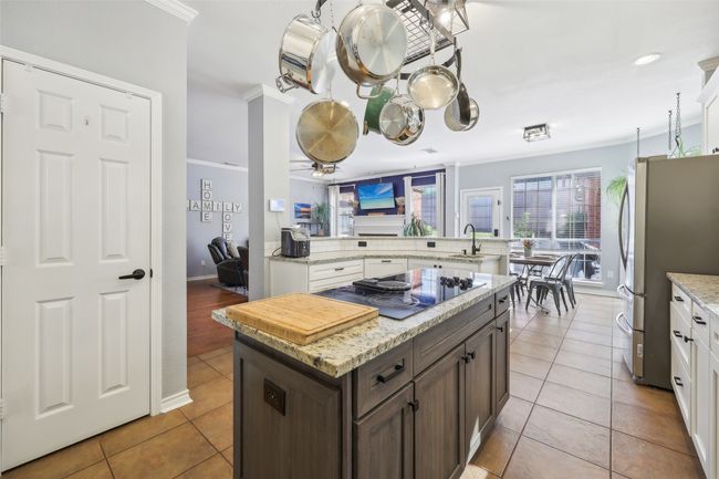 Another view of the updated kitchen, open to the living area and breakfast area. | Image 10