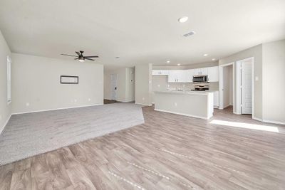 Unfurnished living room with light wood-type flooring and ceiling fan | Image 3